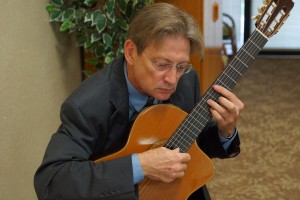 Webmaster Wayne Dooley doubled as entertainer, playing background and Fashion Show music on classical guitar. 